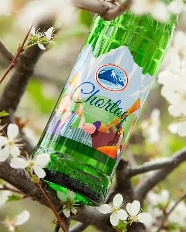 Бутылка Chortoq на ветке цветущей вишни